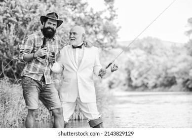 party go. hobby and sport activity. two fishermen with fishing rods. retired businessman. male friendship. mature man fisher celebrate retirement. summer family weekend. father and son fishing