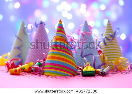Party hats and other stuff on blurred garland background