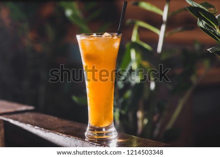 Party and holiday celebration concept. tropical cocktail in a tall glass decorated with ice in the restaurant from the front view