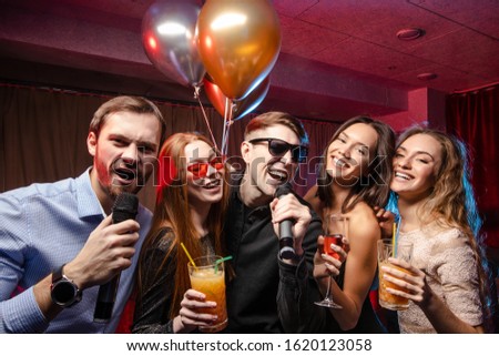 Party, holiday, relax and celebration in karaoke bar, having fun together, singing songs at karaoke. Isolated in room