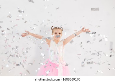 Party, Holidays, Birthday, New Year And Celebration Concept - Cute Child Throwing Confetti.