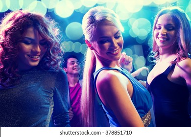 Party, Holidays, Celebration, Nightlife And People Concept - Smiling Friends Dancing In Club