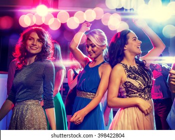 Party, Holidays, Celebration, Nightlife And People Concept - Smiling Friends Dancing In Club