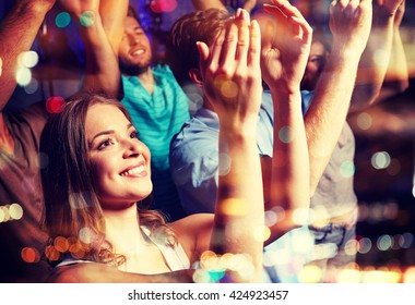 party, holidays, celebration, nightlife and people concept - smiling friends applauding at concert in club - Shutterstock ID 424923457