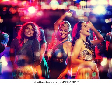 party, holidays, celebration, nightlife and people concept - happy friends dancing in club with holidays lights - Shutterstock ID 433367812