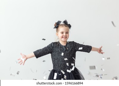 Party, Holidays, New Year And Celebration Concept - Female Child Throwing Confetti.