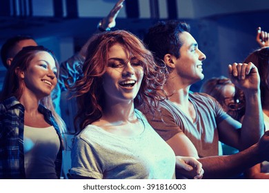 Party, Holidays, Nightlife And People Concept - Happy Friends Dancing At Night Club