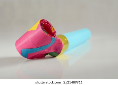 Party horns on colorful confetti stillife