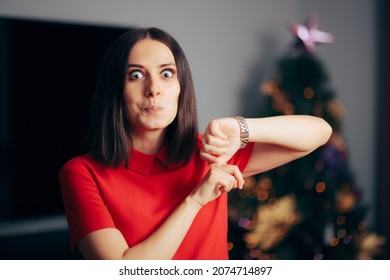 Party Host Pointing To The Clock On Christmas Eve. Funny Woman Planning Xmas Party Reminding Everyone To Hurry Up
