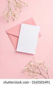 Party invitation concept. Top view vertical photo of pink envelope paper sheet and white gypsophila flowers on isolated pastel pink background with empty space - Shutterstock ID 2165501491