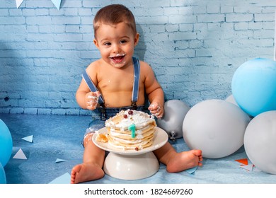 Party for one year baby boy with a set composed of balloons, ribbons, and brick wall paper and pancakes.
