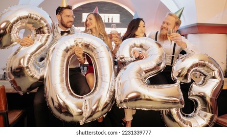 Party people women and men celebrating new years eve 2023 - Shutterstock ID 2231339777