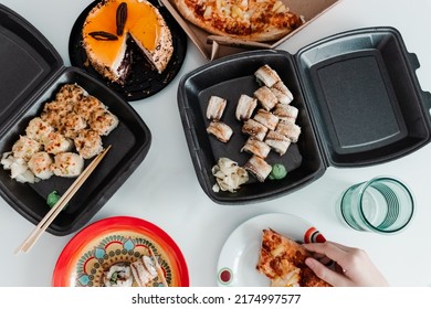 Party Table With Take Out Food In Plastic Package. Pizza, Sushi Rolls And Cake Photo For Menu. Combo Set Of Rolls And Pizza. Eating Home Delivered Food. Food Delivery Top View On White Background.