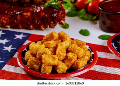 Party Table With Tater Potatos And BBQ Ribs For Independence Day July 4th.