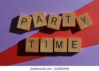 Party Time, words in wooden alphabet letters isolated on bright and colourful background - Shutterstock ID 2110033940