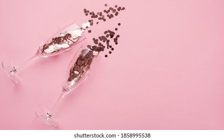 Partying concept. Top above overhead view close up photo of two champagne flutes full of confetti isolated on patel pink background with copyspace - Powered by Shutterstock