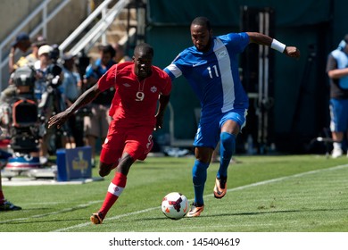 PASADENA, CA - JULY 7: Tosaint Ricketts #9 Of Canada & Yoann Arquin #11 Of Martinique During The 2013 CONCACAF Gold Cup Game Between Canada & Martinique On July 7, 2013 At The Rose Bowl In Pasadena.