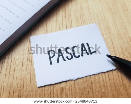 Pascal writting on table background.