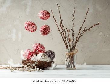 Paschal still life with flying Pysanky and pussy willow branches. Easter eggs decorated with wax resist technique, traditional for Eastern European cultures