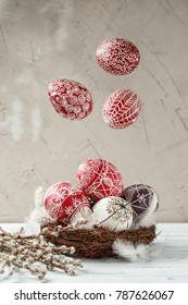 Paschal still life with flying Pysanky and pussy willow branches. Easter eggs decorated with wax resist technique, traditional for Eastern European cultures