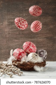 Paschal still life with flying Pysanky and pussy willow branches. Easter eggs decorated with wax resist technique, traditional for Eastern European cultures