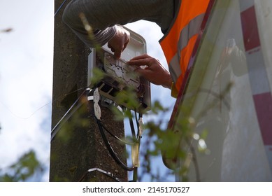 Pas-de-Calais, France-May 25 2021: an engineer in a van-based cherry picker  installing a suspended fibre optic network in a rural village