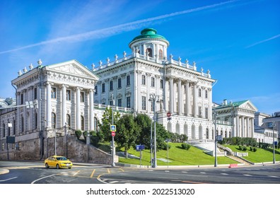 Pashkov's House In Moscow And A Yellow Taxi Car On A Sunny Summer Day
