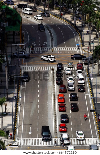 PASIG CITY, PHILIPPINES - JUNE 15, 2017:\
Private and public vehicles at an intersection in Pasig City,\
Philippines during the rush hour in the\
morning.