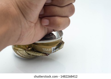 Pasir Gudang, Johore - August 15 2019. A Man Hand Fist Hit The Caffeine Drink Can To Show That Caffeine Drink Is Not Good For Health Over White Background. Danted Can.