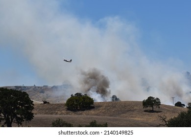 Paso Robles, California, USA - Circa July 2020: Fire Fighting Aircraft Flies Over A Wildfire On Acreage Near Paso Robles, California