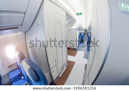 Passage on a passenger plane next to the toilet in economy class