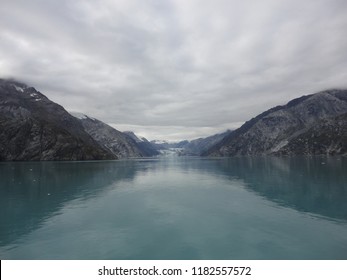 Passage in the Pacific Ocean between two mountain ranges. Calm peaceful waters flowing slowly under a cloudy sky.