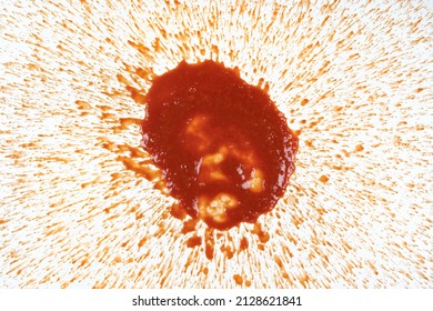 Passata Tomato Sauce Splattered In A Mess On A White Background.