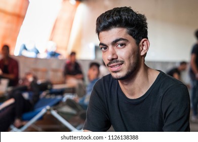 Passau, Germany - August 2, 2015: Young Syrian refugee at a camp in Passau, Germany. The police and several organisations try to push them through registration fast in order to manage the critical sit