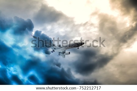 Passenger aeroplane throught turbulent thunderstorm and lightnings