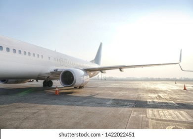 Passenger Aircraft At The Airport Near The Terminal. Unloading And Loading Baggage. Stock Photo