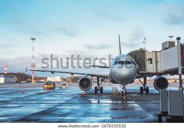 Passenger\
aircraft with boarding stairs, waiting for boarding passengers and\
baggage before the flight, airport\
trip