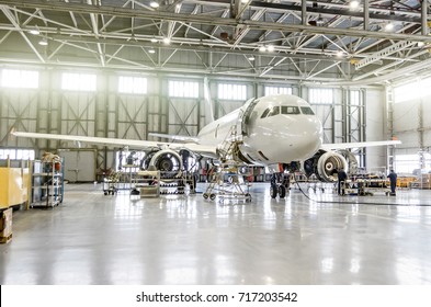 Passenger Aircraft On Maintenance Of Engine And Fuselage Repair In Airport Hangar