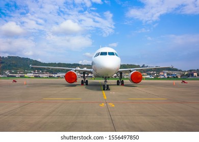 Passenger Aircraft Parked At The Airport With Covered Red Covers Engines