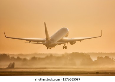 Passenger Airplane Take Off In Morning Fog