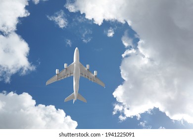 Passenger airplane taking off passing overhead in deep blue cloudy sky as shot from the ground