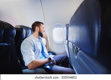 Passenger Of Airplane Talking On Mobile Phone