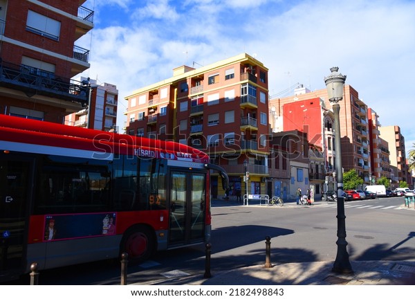 Passenger bus on road. Red city bus travels down
street in city. Public transport and city buses in Eurupe. Сity
street, road traffic, cars on road, people and buildings. Dec 09,
2021, Spain, Valencia