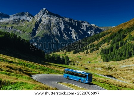 Passenger bus riding at Swiss Alps mountains in summer