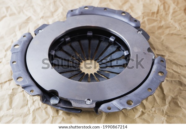 Passenger car clutch basket. Photo of a new clutch\
on a background of craft\
paper.