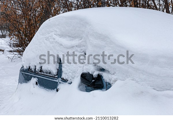 passenger car completely covered with snow
after a snowfall.
(Corrected)