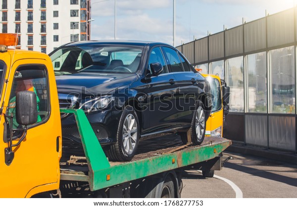 Passenger car loaded onto a recovery truck
for transportation
