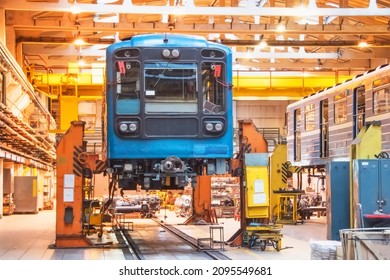 Passenger Carriage Locomotive Of The Subway, Electric Transport In The Depot On Suspended Jacks For Service Maintenance