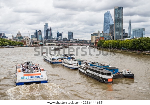 A\
passenger craft on the River Thames in London travels east towards\
Tower Bridge and the Square Mile in July\
2022.