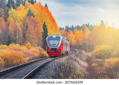 Passenger Diesel Local Train Moves At Autumn Sunset Time. Karelia. Russia.